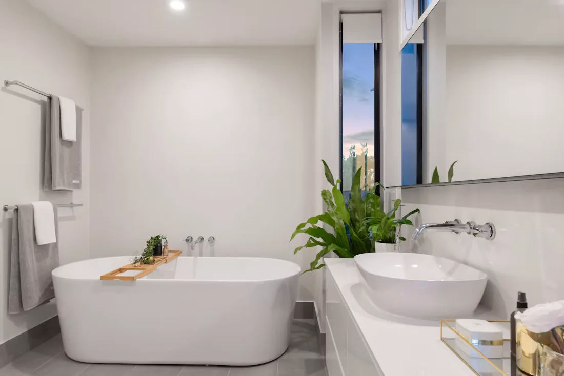 Light-filled bathroom with a freestanding tub, floating vanity and vessel basin
